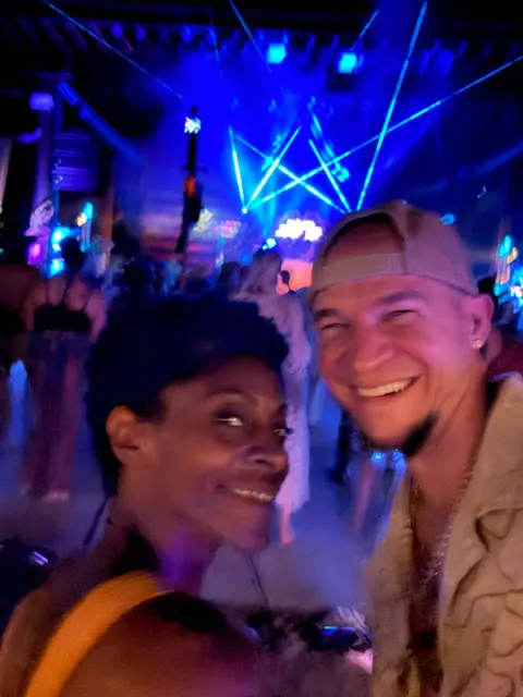 Angel and Tyler, cheek to cheek under lasers