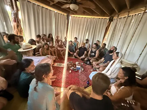 The circle in the cabana, around an altar on a red rug