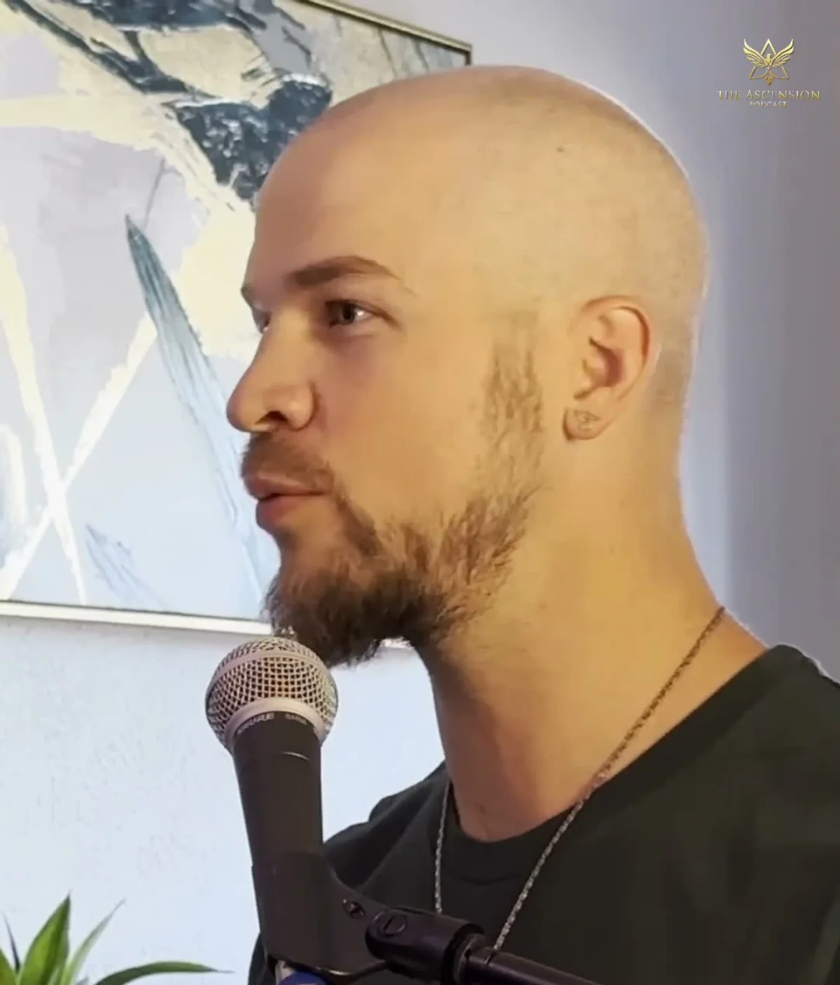 Tyler at the microphone recording a podcast