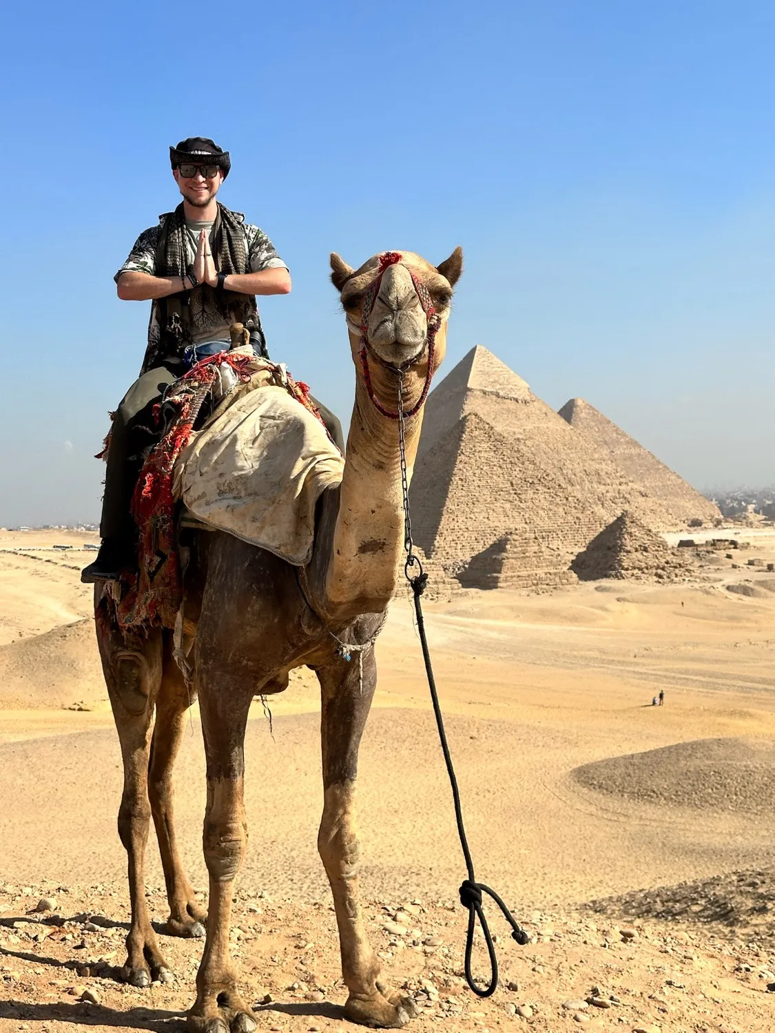 Tyler on a camel before the pyramids of Giza