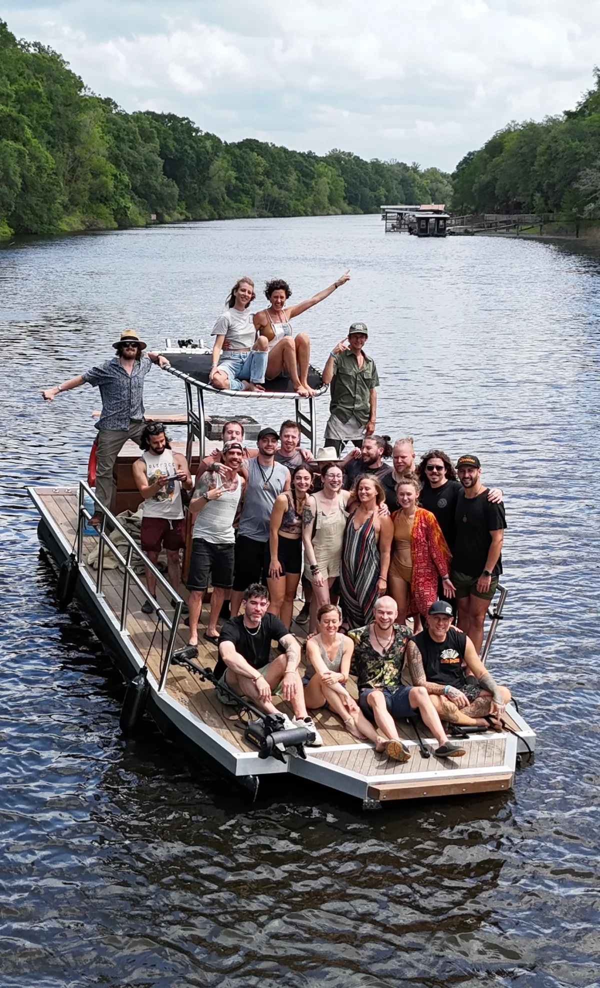 Aerial view of the Ancient Future Collective community gathered on a boat in the Louisiana bayou