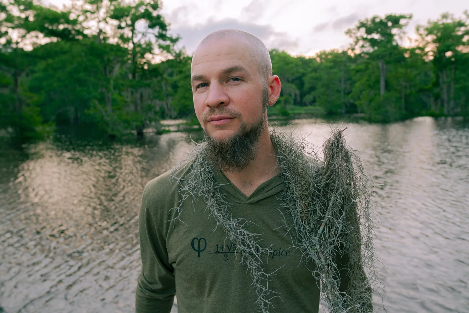 Tyler draped in river plants in the bayou