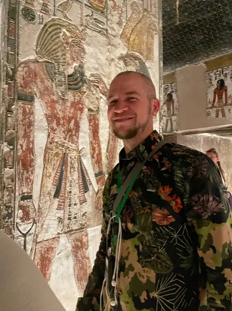 Tyler before ancient tomb paintings